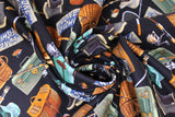 Swirled swatch Fishing Gear fabric (black fabric with tossed fishing gear elements in full colour: wicker baskets, nets, black boots, green hats, assorted lures, green toolboxes, blue "GONE FISHING" sign, etc.)