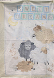 Full panel swatch - Sweet Dreams Panel (44" x 24") (white, grey, and 2 pale brown closed-eyed sheep on white background with clouds and moon, "Sweet dreams" in quilt like squares with a dreamy leaf border)