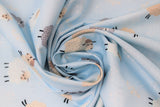 Swirled swatch dreamy sheep fabric (pale blue fabric with small tossed cartoon sheep with closed eyes in brown, grey, and white)