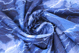 Swirled swatch cracking lightning bolts fabric (light to dark blue coloured fabric mimicking stormy sky with bright lightning lines allover)