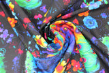 Swirled swatch peacock and flowers fabric (black fabric with tossed blue-bodied rainbow-feathered peacocks, tossed wispy floral lines in blue, orange, red, pink, purple, yellow)