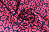 Swirled swatch red lips fabric (black fabric with small and medium sized tossed red lipstick mark look lips allover in various shapes and sizes)