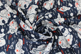 Swirled swatch Danger Pirate Islands fabric (navy blue fabric with treasure map look islands with symbols/emblems related to pirates, white wave lines in water, "Ahoy" "Danger" etc. text in red)