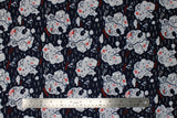 Flat swatch Danger Pirate Islands fabric (navy blue fabric with treasure map look islands with symbols/emblems related to pirates, white wave lines in water, "Ahoy" "Danger" etc. text in red)