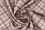 Swirled swatch rustic plaid fabric (tan fabric with diagonal plaid stripe lines in brown and pink)