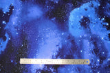 Flat swatch night sky fabric (light to dark blue marbled look galaxy sky style fabric with many white star dots)