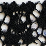 Swatch of black stretch lace on a white background