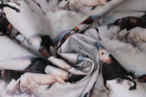 Swirled swatch border style (pattern in lines) fabric with white/grey/brown/black horses galloping through white clouds with sunset sky poking through slightly
