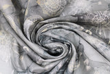 Swirled swatch journey themed fabric in compass toss (medium to dark grey watercolour marbled fabric with light grey compass and globe tossed outlines, directional letters)