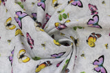 Swirled swatch tossed butterflies fabric (pale grey fabric with subtle cream swirly floral decorative allover and tossed butterflies in yellow, purple and pink colours with small tossed bees and green leaves)