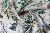 Swirled swatch taupe woodland fabric (pale taupe fabric with tossed coloured woodland emblems in drawn style: leaves and greenery, barn owls on stumps, racoons, bears, mountains, etc.)