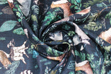 Swirled swatch navy woodland fabric (dark navy fabric with tossed coloured woodland emblems in drawn style: leaves and greenery, barn owls on stumps, racoons, bears, mountains, etc.)