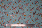Flat swatch blue owls fabric (light blue fabric with tossed drawn style white/grey barn owls in various poses/flight stages and tossed white and orange stars in various sizes, tossed orange crescent and full moons)