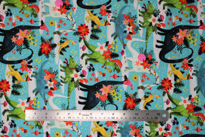 Square swatch Rawring Holidays fabric (light blue fabric with white snow dots and glacier spots with full colour dinos and floral with greenery, dinos wearing christmas hats, poinsettia flowers, stockings, etc.)