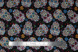 Flat swatch black fabric (black fabric with medium sized tossed sugar skull heads with colourful decorative floral and swirly designs allover in blue, orange, red, green, purple, etc. with tossed floral)