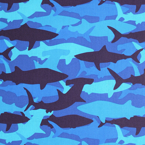 Square swatch medium blue fabric with light to dark blue shark silhouettes in camo style design
