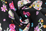 Swirled swatch large fabric (black fabric with large loosely tossed sugar skull heads with colourful decorative floral and swirly designs within, tossed floral heads and birds)