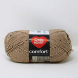 A ball of Red Heart Comfort yarn in shade latte fleck (tan beige with black and white flecks)