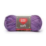 Ball of Red Heart soft yarn in plummy (light to dark pale purples ombre)