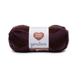 Ball of Red Heart Gemstone yarn in shade ruby (deep purple, black, and burgundy twists)