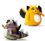 Completed Amigurumi dragons (yellow and multi mini dragons with black and white accents, wings, spikes)