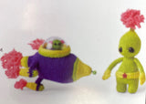 Completed Amigurumi alien and spaceship (small green alien with pink hair sprout, yellow belt with pink star, multi-coloured spaceship with mini alien)