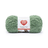 Ball of Red Heart Hygge Fur textured yarn in leafy (pale medium green)