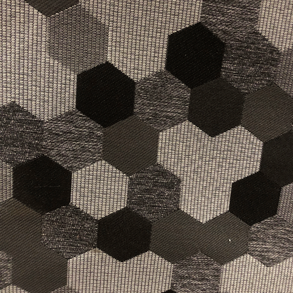 Upholstery fabric in an interlocking hexagons pattern of various shades from dark brown through mid taupe and heathered taupe to light tan