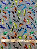 Flat swatch knit material in aeroplanes grey (yellow/orange/green/blue airplanes and helicopters on grey)