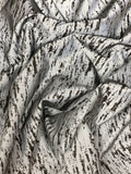 Crinkled swatch silver reflective fabric with black abstract/scratched look