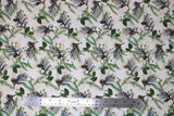 Flat swatch winter flannel in pinecones on cream (cream fabric with tossed green and brown tree sprigs and pinecones, green leaves, white floral)