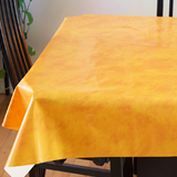 Yellow Suede (lightly textured bright yellow) opaque vinyl draped over a dining room table with matching chairs around it.