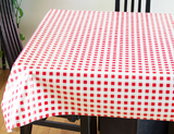 Red & White Check (rows of red squares on a white background, resembling gingham) opaque vinyl draped over a dining room table with matching chairs around it.