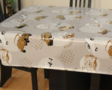 Cars (taupe and white vintage sedan cars and diamond plate steel patches scattered around off-white circles on a tan background, with occasional words like "roma" and taupe line drawings) opaque vinyl draped over a dining room table with matching chairs around it.