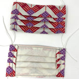 Front and back view of mask with white elastic ear loops (off white mask with red and purple chevron pattern with small feathers in orange and white)