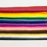 A side-view of a stack of felt in a rainbow of shades