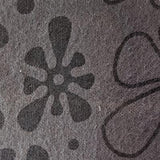 Swatch of mid grey flannel fabric printed with slightly darker grey 'groovy' flowers that somewhat resemble amoebas.