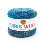 A cake of Lion Brand Ferris Wheel in colourway Full Moon (twisted strands of blue shades including navy, peacock, and pastel)