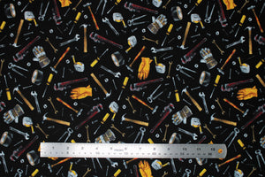 Square swatch Tossed Tools fabric (black fabric with tossed tools allover in drawn style, full colour: hammers, wrenches, nails, screws, tape measures, gloves, tape, etc.)