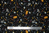 Flat swatch Tossed Tools fabric (black fabric with tossed tools allover in drawn style, full colour: hammers, wrenches, nails, screws, tape measures, gloves, tape, etc.)