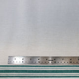 Flat swatch tea towelling material with green stripe accents on white