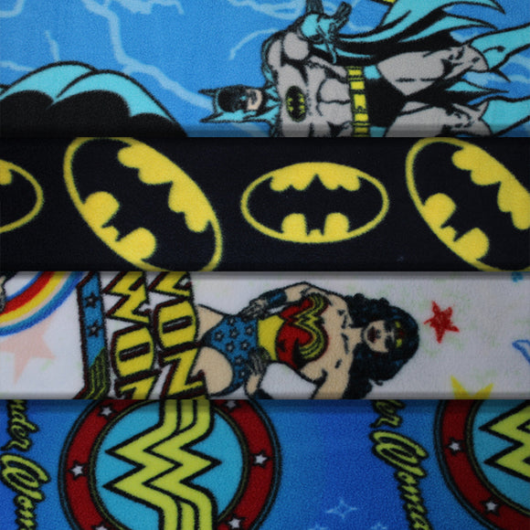Group swatch assorted DC comic printed fleece fabrics in various styles/colours