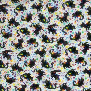 Square swatch Nick fabric (white fabric with tossed cartoon black cats allover with splattered rainbow coloured paint look allover)