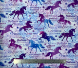 Flat swatch Light Sky fabric (light blue and purple marbled sky fabric with white and blue stars and purple text allover "Believe in Yourself' "Believe in Magic" etc with tossed blue and purple galaxy sky coloured unicorn silhouettes)