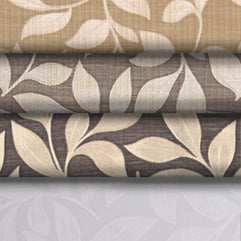 Stack of 4 drapery weight fabric bolts in various colours all with a leaf/greenery pattern