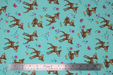 Flat swatch jersey print fabric with woodland theme in print bambi (light blue/turquoise fabric with cartoon baby deer and small butterflies, birds, and flowers)