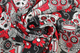 Swirled swatch Red Sugar Skulls fabric (black fabric with busy tossed white and grey decorative skulls with red accents and floral allover, sugar skull style)