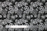 Flat swatch Black Sugar Skulls fabric (black fabric with busy tossed white and grey decorative skulls with floral accents allover, sugar skull style)