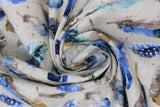 Swirled swatch feather themed print in feathers (natural/light beige coloured fabric with assorted size blue/brown/white feathers with dull gold flecks)