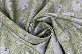 Swirled swatch Lilliput fabric (pale green fabric with spaced smiling frog heads and tossed dark green doodles allover: floral, bugs, leaves, etc.)